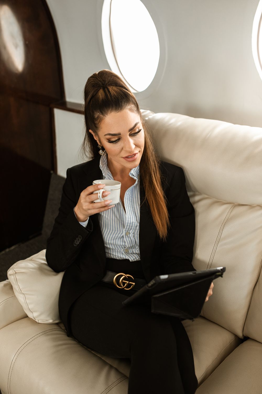 Passenger enjoying coffee in a private jet cabin